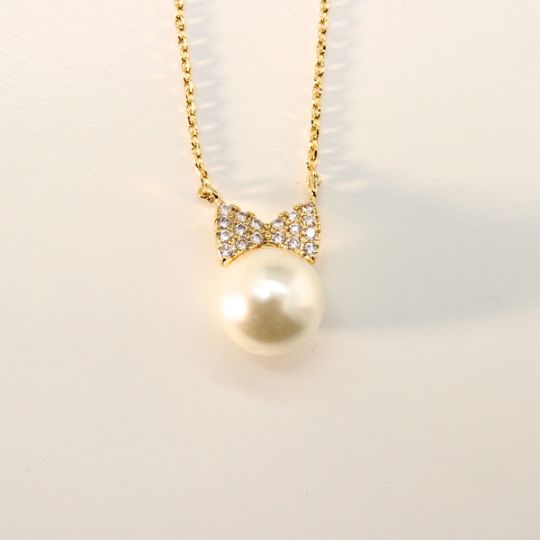 Pearl Bowtie Charm Necklace in Yellow Gold Color Front Close Up